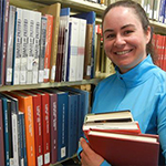 Woman holding books at a library