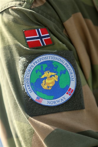 The patch worn by the Norwegian military members who are assigned to the Marine Corps Prepositioning Program-Norway clearly shows the partnership between the two countries.
 
U.S. Marines from 2nd Marine Logistics Group out of Camp Lejeune, NC, in coordination with their Norwegian counterparts, are modernizing some of the equipment currently stored within six caves as a part of the Marine Corps Prepositioning Program-Norway by placing approximately 350 containers of gear and nearly 400 pieces of heavy rolling stock into the storage caves.
 
Planning for this equipment refresh began in the spring of 2010. Marines and contractors from Blount Island Command in Jacksonville, Fla. and Marine Corps Forces Europe and Africa are also in Norway to ensure the operation is conducted in a safe and timely manner.
