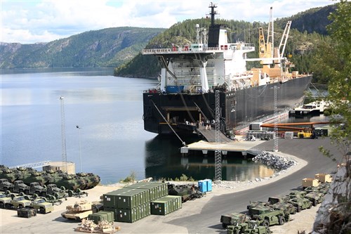 Vehicles and equipment are staged at the designated offload pier during a pre-planned Single Ship Movement and offload of military equipment from a Maritime Prepositioning Force ship in the Trøndelag region of Norway.
 
U.S. Marines from 2nd Marine Logistics Group out of Camp Lejeune, NC, in coordination with their Norwegian counterparts, are modernizing some of the equipment currently stored within six caves as a part of the Marine Corps Prepositioning Program-Norway by placing approximately 350 containers of gear and nearly 400 pieces of heavy rolling stock into the storage caves.
 
Specific equipment which will greatly increase the program's readiness includes M1A1 Main Battle Tanks, Tank Retrievers, Armored Breeching Vehicles, Amphibious Assault Vehicles, Expanded Capacity Vehicle (ECV) Gun Trucks and several variants of the MTVR 7-1/2 ton trucks. 