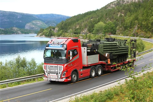 An Amphibious Assault Vehicle is transported by truck from the offload location to one of six caves which make up the Marine Corps Prepositioning Program-Norway during an equipment modernization operation.
 
U.S. Marines from 2nd Marine Logistics Group out of Camp Lejeune, NC, in coordination with their Norwegian counterparts, are modernizing some of the equipment by placing approximately 350 containers of gear and nearly 400 pieces of heavy rolling stock into the storage caves. 

This equipment will significantly enhance the readiness of the Marine Corps Prepositioning Program-Norway by placing approximately 350 containers of gear and nearly 400 pieces of heavy rolling stock into the storage caves.
 
Specific equipment which will greatly increase the program's readiness includes M1A1 Main Battle Tanks, Tank Retrievers, Armored Breeching Vehicles, Amphibious Assault Vehicles, Expanded Capacity Vehicle (ECV) Gun Trucks and several variants of the MTVR 7-1/2 ton trucks. 
