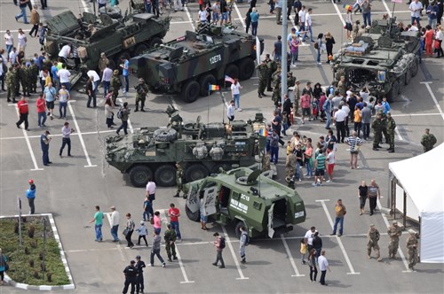 Stryker Combat Vehicles belonging to 2nd Squadron, 2nd Cavalry Regiment, along with Romanian tactical vehicles belonging to the Romanian Land Forces, are put on display for spectators in Ploiesti, Romania, during the unit's demonstration of partnership with its NATO allies while participating the squadron's Cavalry March from Mihail Kogalniceanu Air Base to the Cincu Training Center, May 13, 2015. This event will not only focus on transporting Troopers and their equipment to a new Romanian Training Facility, but it will also give the unit a chance to interact with the local populace while improving on relations with their host nation in support of Operation Atlantic Resolve-South. (U.S. Army photo by Sgt. William A. Tanner/released)