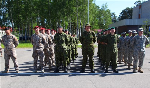 Members of the U.S., Latvian, Canadian, and Estonian Armies await the start of the Saber Strike opening ceremonies on Camp Adazi, Latvia, on June 10, 2012.  Saber Strike 2012 is a U.S. Army Europe led theater security cooperation exercise conducted in the Baltic States. One of the major goals of the exercise is to improve NATO interoperability and strengthens the relationship between military forces of the U.S., Baltic nations and other participating nations. 