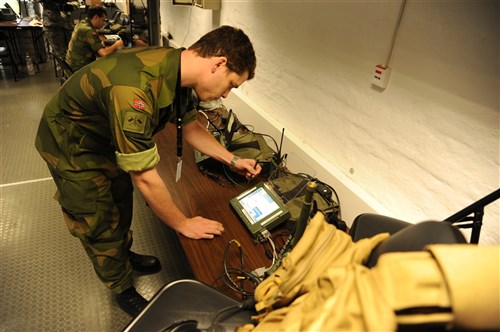 GRAFENWOEHR, Germany (Sept. 14, 2011) – Trond Bjerke, a civilian with the Norwegian defense center, checks the Blu Force tracking computer equipment during Combined Endeavor 2011 in Grafenwoehr, Germany, Sept. 13. Combined Endeavor 2011 is a multi-nation exercise designed to increase interoperability and communication between more than 40 participating countries. (U.S. Air Force photo by Senior Airman Adawn Kelsey/Released)