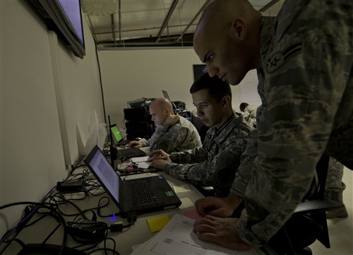 (Right to left) U.S. Air Force Airman 1st Class Aaron Stephenson, tactical network operations technician, and U.S. Army Spc. Edgar Gonzalez, information technology specialist, review work orders during Combined Endeavor 2012 at the Joint Multinational Training Command, Grafenwoehr, Germany, Sept. 9, 2012. Gonzalez is from the  35th Signal Battalion, U.S. Army Reserve, Fort Allen, Juana Díaz, Puerto Rico, and Stephenson is from the 1st Combat Communications Squadron, Ramstein Air Base, Germany.  CE12 is a multinational command, control, communications and computer systems exercise designed to build and enhance communications and network interoperability between 41 nations and  international organizations.