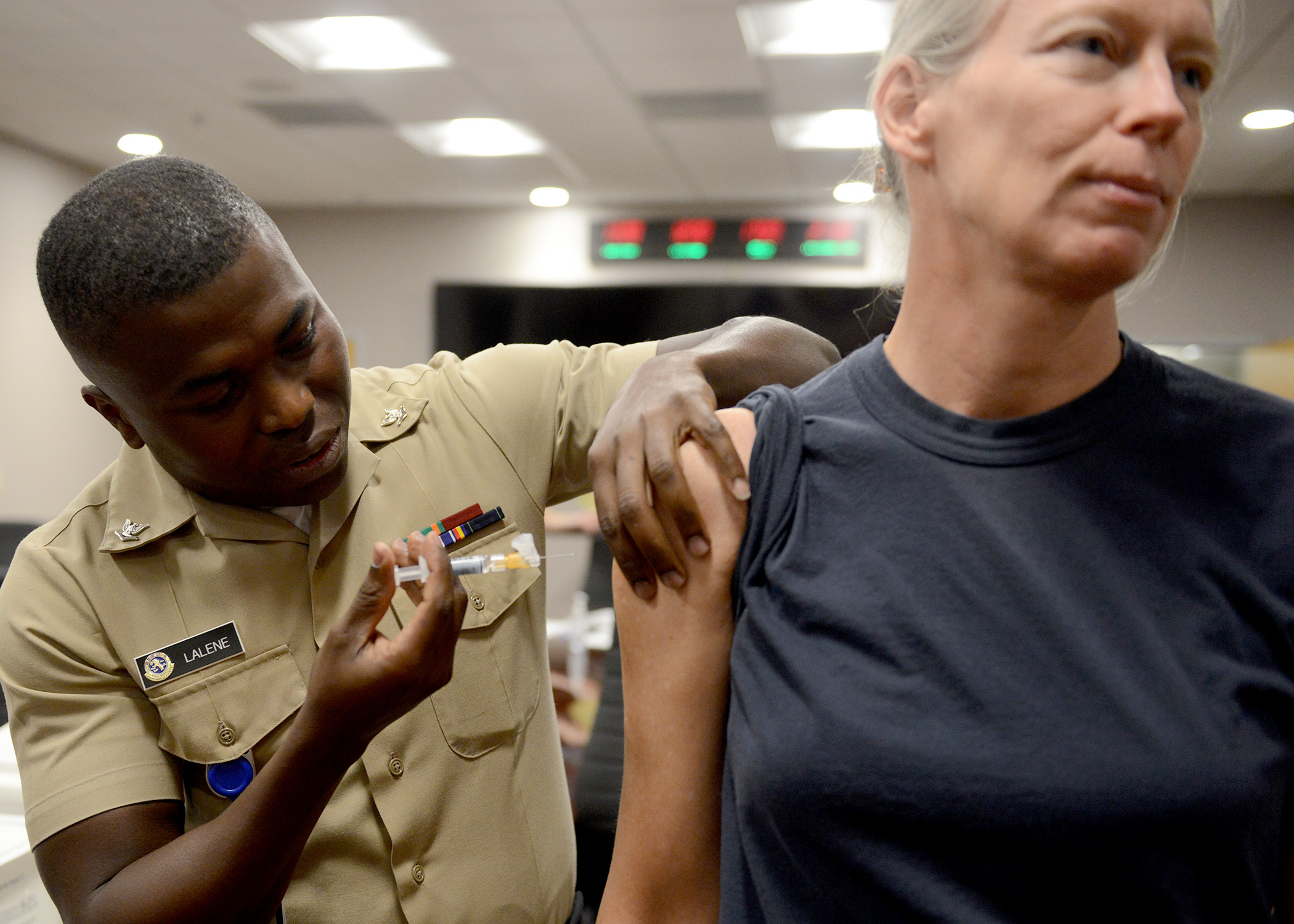 Commander, Navy Region Southeast, Rear Adm. Mary Jackson gets a flu shot at region headquarters on board Naval Air Station Jacksonville. Vaccination is the first and most important step in protecting against the flu, and a requirement for active duty military personnel, selected reserves, and health care workers. It’s also recommended that civilian employees see their health care provider to be immunized and protected for the coming flu season. (U.S. Navy photo by Petty Officer 1st Class Stacy D. Laseter/Released)