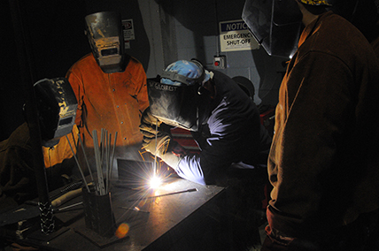 Steelworker 1st Class Michael Gilchrest, a Naval Construction Training Center A School welding instructor, demonstrates proper technique before a hands on welding project Sept. 6. The students are in their second week of ARC welding. (U.S. Navy photo by Brian Lamar, NCBC Public Affairs)