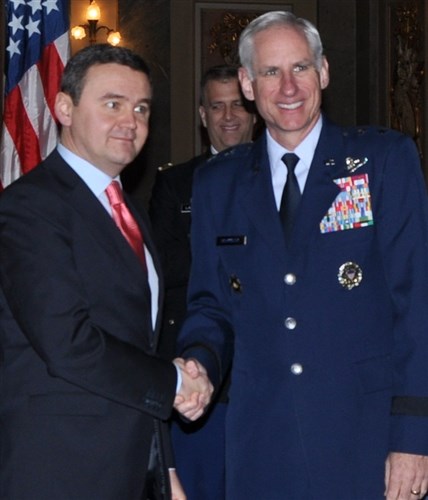 Maj. Gen. Mark O. Schissler, EUCOM J5/8 director, and fellow co-chair of the United-States Romania Joint Committee Sebastian Huluban, Romanian State Secretary for Defense Planning and Policy, shake hands during the event Dec. 18 in Bucharest.