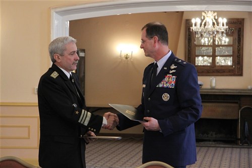 Maj. Gen. Randy Kee, director of U.S. European Command's Policy, Strategy, Partnering and Capabilities Directorate (right), shakes hands with Bulgarian Deputy Chief of Defense Rear Adm. Georgi Georgiev (left), upon completion of the 10th Bulgaria/U.S. Joint Commission meeting Jan. 9, 2014, in Stuttgart, Germany.