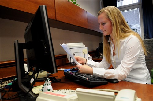 STUTTGART, Germany -- Brittani Lundbye, U.S. European Command Policy, Partnering, and Capabilities directorate (J5/J8) executive assistant processes paperwork for J5/J8.  Lundbye  was recently named EUCOM’s civilian of the year in paygrades GS1 to GS8.