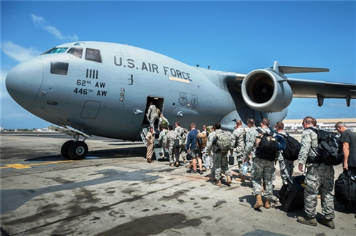 A group of 30 U.S. military personnel, including Marines, airmen, and soldiers from the 101st Airborne Division, board a U.S. Air Force C-17 Globemaster III at Léopold Sédar Senghor International Airport in Dakar, Senegal, Oct. 19, 2014. The service members were bound for Monrovia, Liberia, to construct medical treatment units and train health care workers as part of Operation United Assistance, DoD's support to the USAID-led, whole-of-government effort to respond to the Ebola outbreak in West Africa. Air National Guard photo by Maj. Dale Greer 