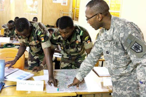 Nigerien Army Lieutenants Ismaila Abdou Hamza and Aboubacar Anadon and U.S. Army Capt. Dominique Louis plot targets for analysis during their basic map-reading course in Niamey, Niger, Oct. 28, 2015.