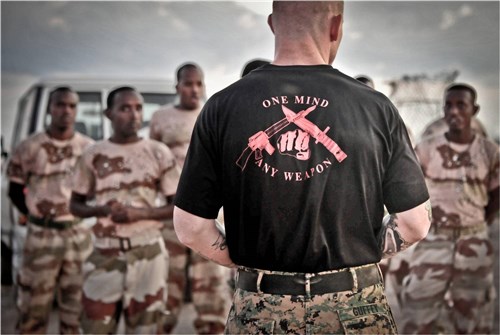 CHEIK MOUSSA, Djibouti (Nov. 19, 2011) - U.S. Marine Gunnery Sergeant Josh Guffey, Marine Corps Martial Arts Program instructor trainer, Marines 2nd Battalion, 2nd Marine Regiment Battalion Landing Team, based at Camp Lejeune, North Carolina, briefs members of the Group d' Intervention de la Gendarmerie Nationale on combat fitness events for the day during MCMAP training at Cheik Moussa, Djibouti, November 19. Guffey, a native of Viper, Kentucky, joined a training team of several other Marines from the USS Bataan (LHD 5) to participate with members of the GIGN in bilateral training involving infantry-specific skills, such as close combat tactics and techniques, enhanced marksmanship and vehicle training at Djibouti's Centre d'Instruction Ministere de la Defense, November 13 to December 2. (DOD photo by Supunnee Ulibarri)