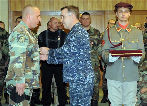SKOPJE, Macedonia &mdash; Navy Rear Adm. Andy Brown, EUCOM logistics director, pins a medal for distinguished service during Operation Iraqi Freedom on a soldier from the Army Republic of Macedonia. Macedonia committed more than 500 soldiers to the operation in Iraq and their forces are currently supporting coalition efforts in Afghanistan. (Photo by Slobodan Guric)