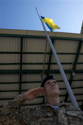 A Ukrainian soldier salutes as the Ukrainian flag is lowered during the closing ceremony for Exercise Rapid Trident 16 in Yavoriv, Ukraine July 8, 2016. The exercise is a regional command post and field training exercise that involves about 2,000 Soldiers from 13 different nations, being held at the International Peacekeeping and Security Center in Yavoriv, Ukraine June 27 - July 8, 2016. (U.S. Army photo by Sgt. 1st Class Whitney Hughes/Released)