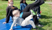 Shannon Coolbaugh (center) and her son Tobin, 3, try one of the workout stations with Jalessa Robinson (right) during Family, Fitness and Fun Day at the Cody Child Development Center on Joint Base Myer-Henderson Hall. The event had a 1-mile course with various workout stations. Photo by Rachel Larue.