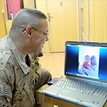 Service member video chatting with family