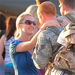 Woman embracing service member