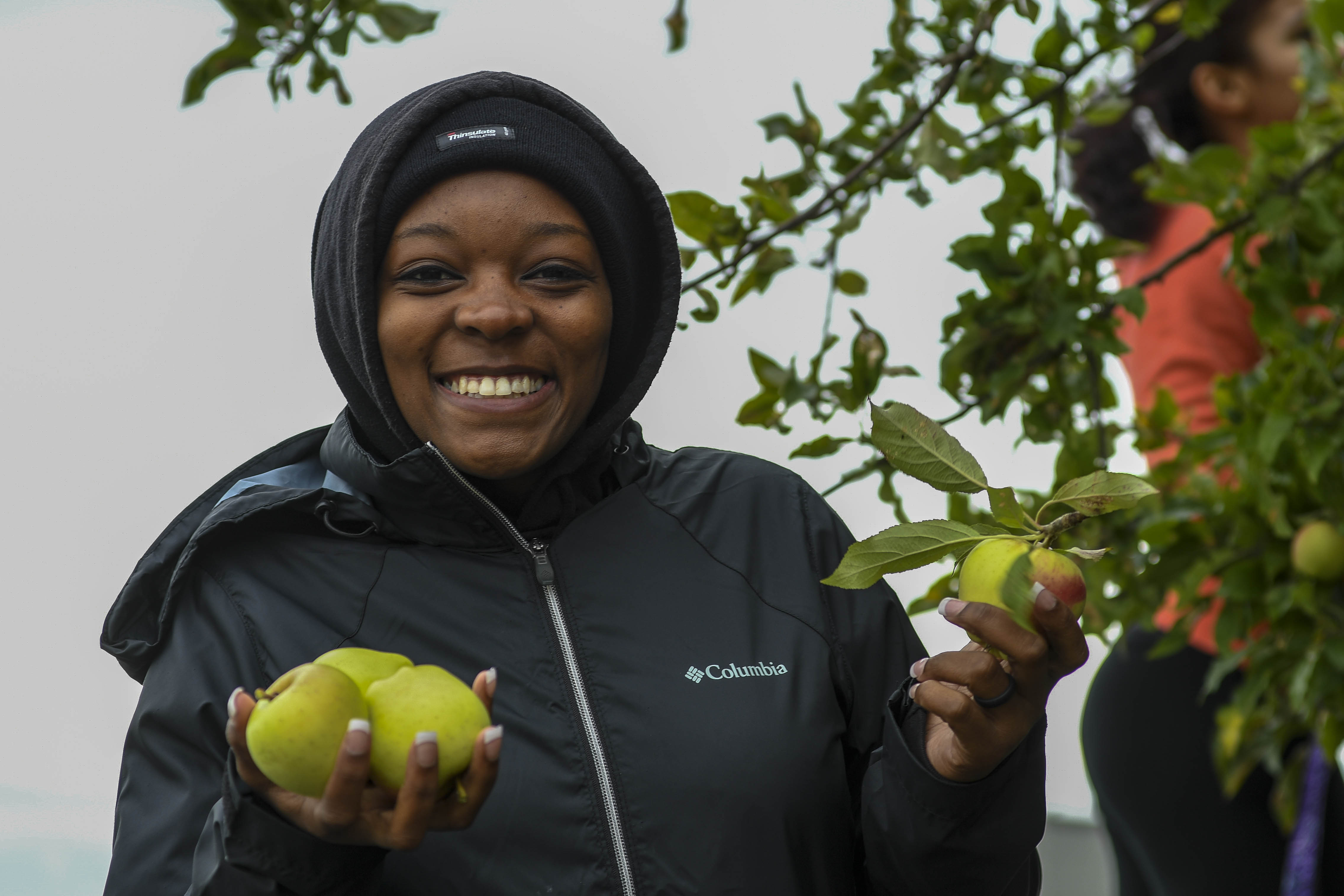 160923-N-WQ574-005 OAK HARBOR, Wash. (Sep. 23, 2016) – Aviation Ordnanceman Airman Kimondria Townsend, from Dallas, assigned to Patrol Squadron Four, poses with apples picked during a community relations event at Naval Air Station Whidbey Island's (NASWI) historic seaplane base. NASWI hosted the event to gather apples for the North Whidbey Help House. (U.S. Navy photo by Mass Communication Specialist 3rd Class Caleb Cooper/Released)