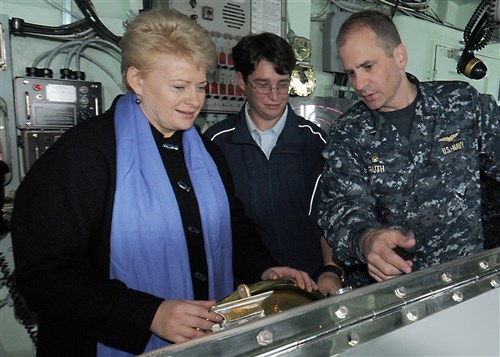 BALTIC SEA (Sep. 21, 2010)- Dalia Grybauskaite, president of Lithuania, operates the helm while Capt. Jeffrey Ruth, commanding officer, USS Mount Whitney (LCC/JCC 20), explains how it maneuvers the ship. Grybauskaite received a tour of the ship during exercise Jackal Stone (JS10) 2010. Mount Whitney is currently operating in the Baltic region in support of exercise JS10, a 10-day special operations exercise featuring participation from Croatia, Latvia, Lithuania, Poland, Romania, Ukraine, and the United States. (U.S. Navy photo by Mass Communication Specialist 1st Class Terry Vick /RELEASED)