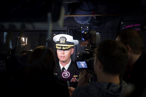 Cmdr. Darren Dugan, commanding officer, USS Jason Dunham (DDG 109) conducts an on-camera interview with Estonian media July 8, 2015. Jason Dunham, an Arleigh Burke-class guided-missile destroyer homeported in Norfolk, is conducting naval operations in the U.S. 6th Fleet area of operations in support of U.S. national security interests in Europe. (U.S. Navy photo by Mass Communication Specialist 3rd Class Weston Jones/Released)