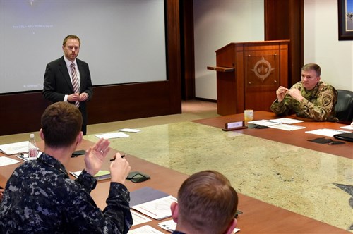 Mr. Chris Macpherson, (left) from EUCOM's Policy, Strategy, Partnering and Capabilities Directorate, presents his submission to Lt. Gen. William B. Garrett III, Deputy Commander of U.S. European Command during the first EUCOM Rapid Innovation Cell forum held Feb. 2, 2016. Macpherson has been assigned to EUCOM for nearly three years and works various posture related issues for the command. (U.S. European Command Photo by Master Sgt. Charles Larkin Sr./Released)
