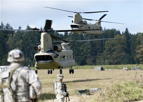 Two Chinook helicopters provide air support during Europe's Full-Spectrum Training Environment rotation, Oct. 3-24, 2011 at Hohenfels Training Area in Germany. The 173rd Airborne Brigade Combat Team conducted a large-scale assault into an austere environment as part of the training.