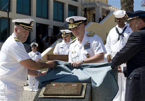 SIGONELLA, Sicily &mdash; U.S. Navy Rear Adm. David J. Mercer commander, Navy Region Europe, Africa, Southwest Asia, commander, Maritime Air Naples (center), and U.S. Navy Capt. Thomas J. Quinn, commanding officer Naval Air Station (NAS) Sigonella (left), assisted by Italian Air Force Col. Luca Tonello, commanding officer 41st Stormo (right), unveil a plaque to commemorate the partnership between the U.S. and Italy at a ceremony for the 50th Anniversary. NAS Sigonella provides logistical support for Commander, 6th Fleet and NATO forces in the Mediterranean area. (Department of Defense photo by Navy Mass Communication Specialist 3rd Class Jonathan P. Idle)