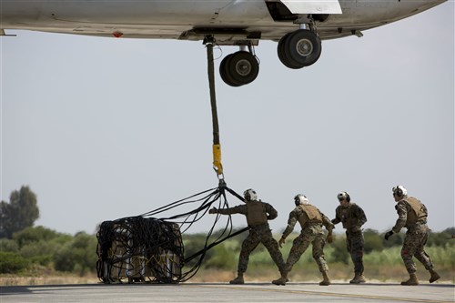 Landing support specialists with Combat Logistics Battalion 2, Special Purpose Marine Air-Ground Task Force-Crisis Response-Africa, attach a 1,098 pound pallet of Meals, Ready to Eat to an MV-22B Osprey during a helicopter support team exercise aboard Naval Station Rota, Spain, July 6, 2016. External lifts allow pilots to deliver large cargo and supplies to Marines located in rough or unknown terrain without having to land the aircraft. (U.S. Marine Corps photo by Staff Sgt. Tia Nagle/Released)