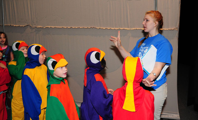 160722-N-WR682-031 FORT WORTH, Texas (July 22, 2016) Darby Bixler, co-director, cues the parrot performers for their entrance during the dress rehearsal of "Blackbeard the Pirate" before the performance at  July 22 at the base theater. The performance was produced by the Missoula Children's Theater and performed by the children of military and civilian employees attached to NAS Fort Worth JRB. (U.S. Navy photo by Karin Krause/Released)