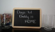 A countdown display sits on a table at the Macri family’s home. The family will move a marble from one jar to the other each day to keep track of how many days until U.S. Air Force Airman 1st Class Ryan Macri returns home from deployment. U.S. Air Force photo by Airman 1st Class Dylan Nuckolls/Released