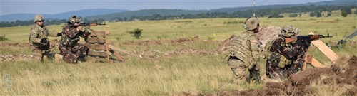 Troopers from 5th Squadron, 7th Calvary Regiment, 1st Armored Brigade Combat Team, 3rd Infantry Division observe Hungarian Soldiers as they engage targets during a stress at Camp Ujamajor, Hungary July 13, 2016. The Troopers are in Hungary as a part of Operation Atlantic Resolve, a demonstration of continued U.S. commitment to the collective defense of Europe through a series of actions designed to reassure NATO allies and partners of our dedication to enduring peace and stability in the region.