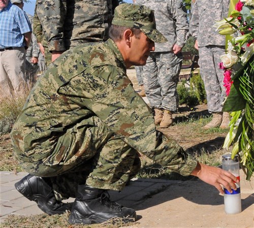 Croatian Army Brig. Gen. Ivan Juric, the exercise deputy commander of Jackal Stone 2012, places a candle during a memorial service held for U.S. Army Master Sgt. Ivica Jerak in Debeljak, Croatia, Sept. 22, 2012. The memorial service took place in Jerak’s hometown at an elementary school that was renovated in his honor in 2009.