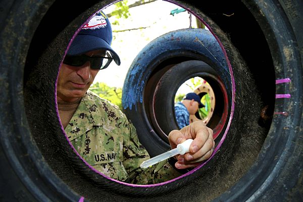 Lt. Cmdr. James Dunford, an entomologist from Twin Lakes, Wis., assigned to Navy Environmental Preventive Medicine Unit-2 based in Norfolk, Va., and Hospital Corpsman 1st Class Luke Peet, assigned to Boone Branch Health Clinic at Joint Expeditionary Base Little Creek, Va., look for mosquito larvae at Escuela de Education Especial de Acajutla, during Continuing Promise 2015. Continuing Promise is a U.S. Southern Command-sponsored and U.S. Naval Forces Southern Command/U.S. 4th Fleet-conducted deployment to conduct civil-military operations including humanitarian-civil assistance, subject matter expert exchanges, medical, dental, veterinary and engineering support and disaster response to partner nations and to show U.S. support and commitment to Central and South America and the Caribbean.  U.S. Army photo by Pfc. Tomarius Roberts (Released)  150617-A-ZA034-036