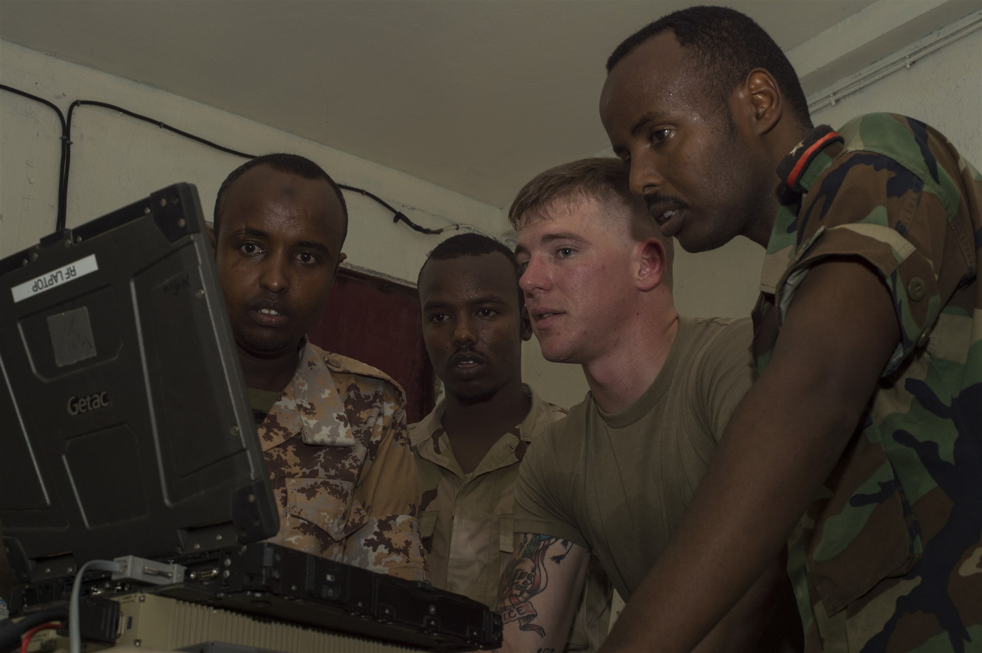 U.S. Army Spc. Dillin Hart, a Combined Joint Task Force-Horn of Africa technician on the Africa Data Sharing Network (ADSN) system, reviews network configurations with members of the Djibouti Armed Forces (FAD) during training validation Sept. 28, 2016, at FAD Headquarters in Djibouti.  While conducting the best practices training, the U.S. Army technicians assigned to Combined Joint Task-Horn of Africa, also held an ADSN validation with the FAD soldiers to prepare them to deploy to Somalia.  The ADSN provides network and Voice over Internet Protocol capabilities between the several African countries participating in the Africa Union Mission in Somalia. (U.S. Air Force photo by Staff Sgt. Eric Summers Jr./Released)