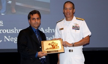 Dr. Kayvan Najarian accepted the 2016 MHSRS Team Award for Outstanding Research Accomplishment in the research category of health information technology/informatics on behalf of his team from Navy Rear Adm. Colin Chinn, director of the Research, Development & Acquisition Directorate of the Defense Health Agency on Wednesday, Aug. 17, 2016. 