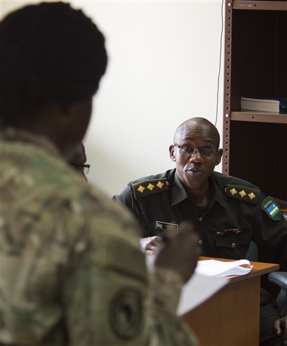 U.S. Army Capt. Morgan Shepard, Combined Joint Task Force-Horn of Africa Public Information officer, listens as Rwanda Defense Force Army Capt. Edouard Turatsinze, Ministry of Defense Public Relations and Communications officer, discusses a topic Feb. 2, 2016, at RDF headquarters, Kigali, Rwanda. CIMIC officers have many of the same roles and responsibilities as U.S. Army civil affairs personnel. Army civil affairs specialists are responsible for researching, coordinating, conducting and participating in the planning and production of civil affairs related documents, while enabling the civil-military operations of the supported commander. (U.S. Air Force photo by Senior Airman Peter Thompson)
