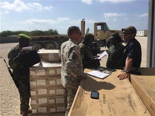 Members of the Uganda People's Defense Force take ownership of communications equipment delivered to them from the U.S. Army to be used in their support to the African Union Mission in Somalia.