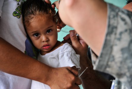 A young Honduran girl has her ear inspected by Spc. Kerry Holmes, Joint Task Force-Bravo Medical Element medic, during a Medical Readiness Training Exercise operation in Trujillo, Honduras, July 29, 2016. MEDEL conducts MEDRETEs throughout Central America to provide a variety of medical services to the local populations, who otherwise would be unable to receive medical care from licensed providers.