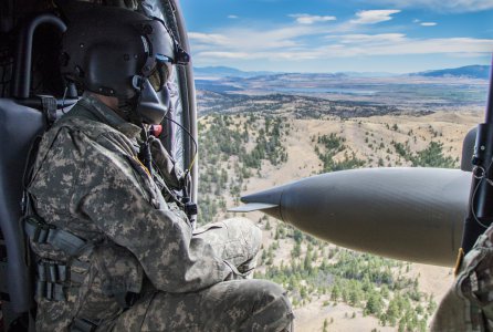 A crew chief of a UH-60M Blackhawk overlooks the scenery above the city of Helena, Mont., Sept. 10, 2016. The Blackhawk was used to transport participants of the Montana National Guard Best Warrior Competition.