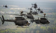 Thirty-two OH-58D Kiowa Warriors conduct a flyover above Fort Bragg, N.C., 2016, during the final stateside flight of the aircraft, April 15, 2016. The OH-58D Kiowa Warrior has been a mainstay in the skies over the area for more than 25 years. DoD photo by Kenneth Kassens