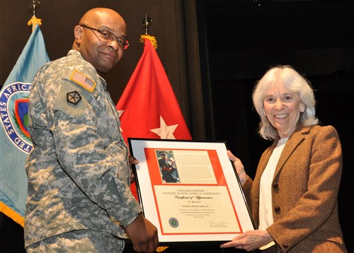 Dr. Barbara Sotirin, U.S. Africa Command Deputy for Programs, presents an award to Army Col. Melvin Jones for his winning essay.  Each of the three essayists were honored as part of U.S. Africa Command’s International Women’s Day event, conducted March 10, 2014, in Stuttgart.  (U.S. Africa Command photo by Brenda Law/Released) 