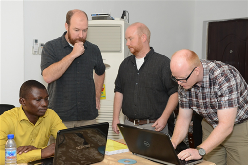 Frederick Kafui Agbleze (far left) in Geographic Information System training, sponsored jointly by U.S. Africa Command and Ghana’s National Disaster Management Office (NADMO), works through an exercise scenario while experts from FEMA and the City of Fargo, North Dakota look on.  The training was conducted in Accra, Ghana, September 16-28.  Left to right are participant Frederick Kafui Agbleze, a research analyst who specializes in statistics and works for NADMO; Gene Longnecker, a senior physical scientist and manager of the National Earthquake Hazards Reduction Program (NEHRP) for FEMA Region IV, Jesse Rozelle, risk analyst/GIS coordinator for FEMA Region VIII and Brady Scribner, strategic national stockpile and city readiness coordinator for the city of Fargo, ND.   Longnecker, Rozelle and Scribner were recruited by the North Dakota Army National Guard, to develop and conduct GIS training in Ghana.  A state partner for the past ten years, North Dakota has been active in partnering with Ghana to plan, develop and execute programs and training that build capacity in Ghana’s ability to conduct disaster management operations.  (U.S. AFRICOM photo by Brenda Law)