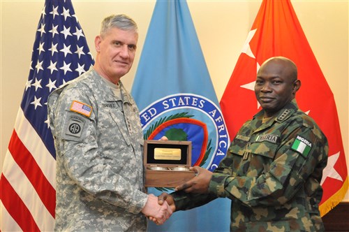 Gift exchange: Gen. David Rodriguez, commander, U.S. Africa Command (left), presents a gift of appreciation to Gen. Abayomi Olonisakin, Nigeria chief of defence staff. AFRICOM hosted a two-day meeting that brought together AFRICOM component commanders and several senior members of the Nigerian military.  The purpose of the visit was to reinforce the importance of a strong US-Nigeria security cooperation relationship, with topics focused on ways to counter terrorism, joint operations, logistics and maritime security in the Gulf of Guinea, Feb. 10, 2016, U.S. Army Garrison Stuttgart, Germany. (Photo by Brenda Law, U.S. Africa Command Public Affairs/RELEASED)