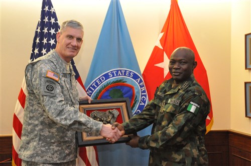 Gift exchange: Gen. Abayomi Olonisakin, Nigeria chief of defence staff (right) presents a gift of appreciation to Gen. David Rodriguez, commander, U.S. Africa Command.  AFRICOM hosted a two-day meeting that brought together AFRICOM component commanders and several senior members of the Nigerian military.  The purpose of the visit was to reinforce the importance of a strong US-Nigeria security cooperation relationship, with topics focused on ways to counter terrorism, joint operations, logistics and maritime security in the Gulf of Guinea, Feb. 10, 2016, U.S. Army Garrison Stuttgart, Germany. (Photo by Brenda Law, U.S. Africa Command Public Affairs/RELEASED)