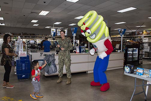 SANTA RITA, Guam (Oct. 14, 2016) -- Mr. Brite greets a young customer at the U.S. Naval Base Guam (NBG) Navy Exchange Home Store during an Energy Awareness display, Oct. 14.  Highlights of NBG's energy initiatives include the awarding of a $15.6 million contract to upgrade Heating, Ventilation and Air Conditioning (HVAC) units.  Eleven U.S. Naval Base Guam (NBG) facilities will soon receive ENERGY STAR-certified HVAC units with new high performance technology and high-energy efficient Variable Refrigerant Flow (VRF) systems, resulting in an annual savings of more than $1.38 million. Work is planned to begin in January or February 2017.