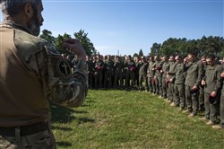 A Ukrainian Armed Forces Chaplain and Ukrainian National Guard Soldiers finish a prayer at the closing ceremony for Exercise Rapid Trident 16 in Yavoriv, Ukraine July 8, 2016. The exercise is a regional command post and field training exercise that involves about 2,000 Soldiers from 13 different nations, being held at the International Peacekeeping and Security Center in Yavoriv, Ukraine June 27 - July 8, 2016. (U.S. Army photo by Sgt. 1st Class Whitney Hughes/Released)