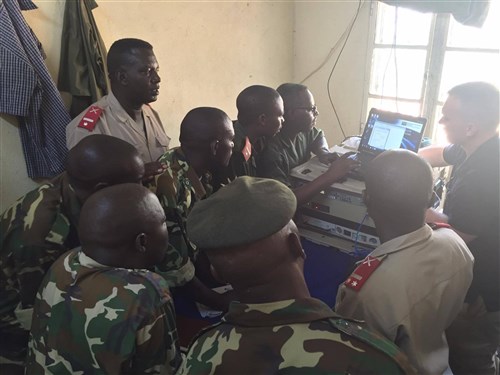 Burundian National Defense Force Soldiers take notes as Nevada National Guard Spc. Richard Taylor, 422d Expeditionary Signal Battalion, currently assigned to CJTF-HOA’s communications unit, shares lessons learned and best practices for operating their African Data Sharing Network terminal June 8-17, 2016, at Bujumbura, Burundi. The soldiers led a sharing of best practices for installing, operating, and maintaining their African Data Sharing Network satellite terminal. The ADSN communication package provides a dynamic intelligence sharing platform for the African Union Mission in Somalia’s troop contributing countries. (U.S. Army photo by 1st Lt. Justin R. Klatt/Released)