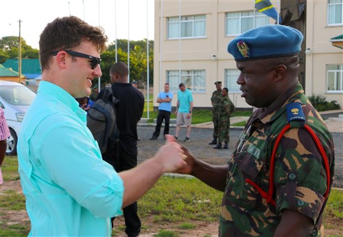 Tanzanian People’s Defense Force Lt. Col. Hozza teaches a popular Tanzanian handshake to Capt. Bryan Neal, operations planner for 1st Battalion, 9th Field Artillery Regiment, 2nd Brigade Combat Team, 3rd Infantry Division, during the exercise Eastern Accord 2016 final planning event site visit to the Tanzanian Peacekeeping Training Center in Dar es Salaam, Tanzania, May 3. Soldiers of 1-9 FA are supporting EA 2016 this summer as part of the regionally allocated force for U.S. Army Africa and U.S. Africa Command. (U.S. Army Africa photo by Capt. Jarrod Morris)