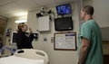 Sonja Lawson, a registered nurse at Baptist Health hospital in Little Rock, Arkansas, waves at the monitor to Kristen Davis and Thomas Hedrick, registered nurses in General Leonard Wood Army Community Hospital's Intensive Care Unit.