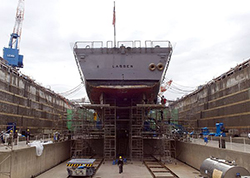 Contractors from the Fleet Activities Yokosuka Ship Repair Facility perform maintenance on the guided-missile destroyer USS Lassen (DDG 82) as it rests in dry dock. Lassen, assigned to Destroyer Squadron 15, is currently undergoing a scheduled dry dock ship's restricted availability.(U.S. Navy Photo by Mass Communication Specialist 2nd Class Brock A. Taylor/Released)